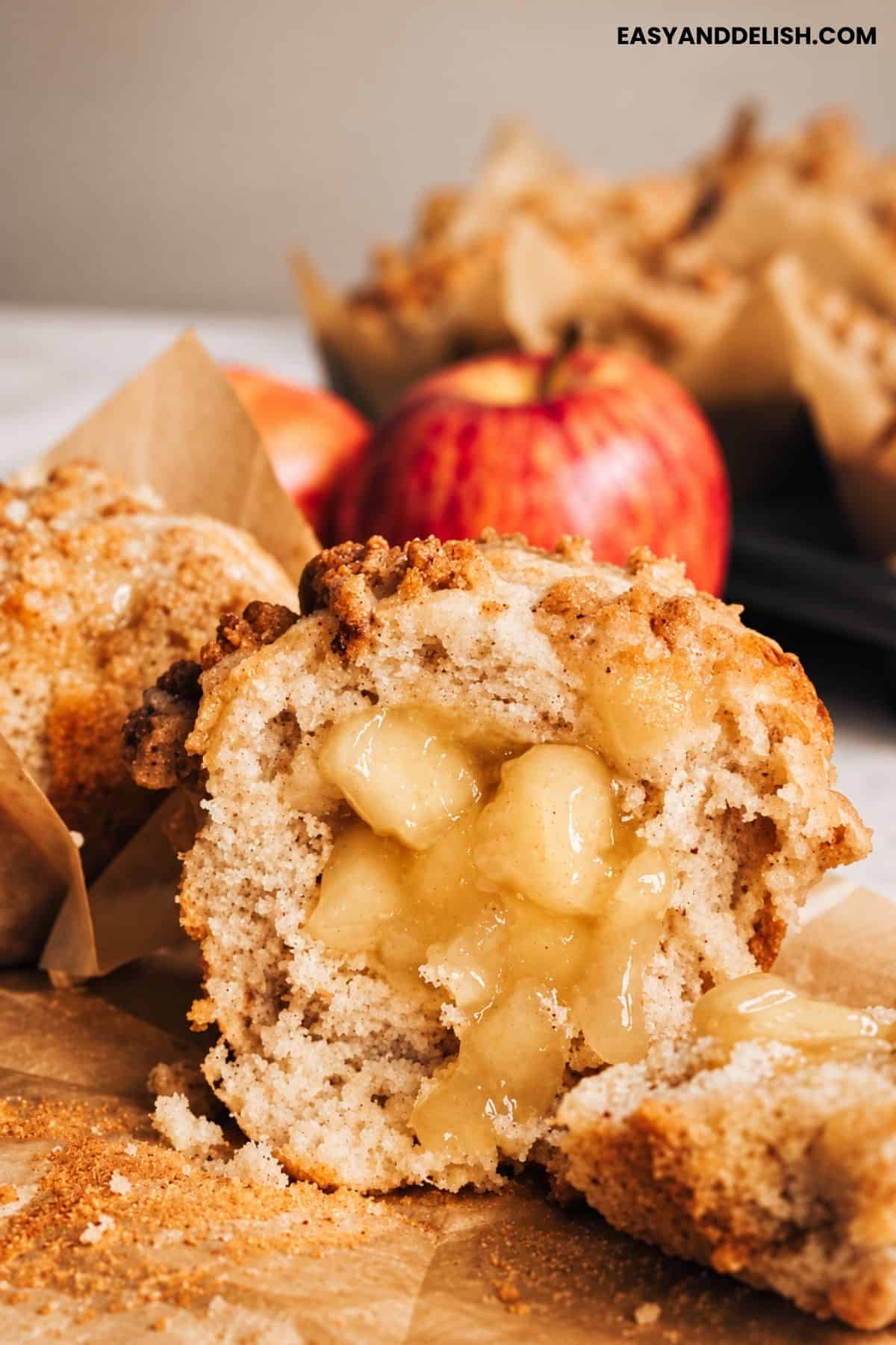 Muffin with apple pie filling in the center and crumble topping.