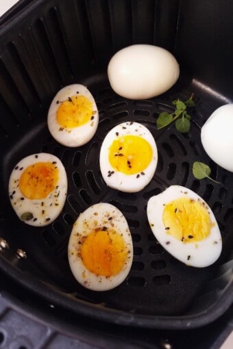 cooked eggs in an air fryer basket