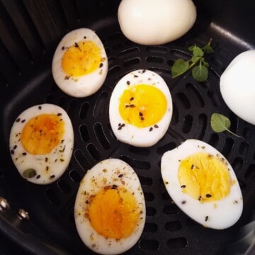 cooked eggs in an air fryer basket
