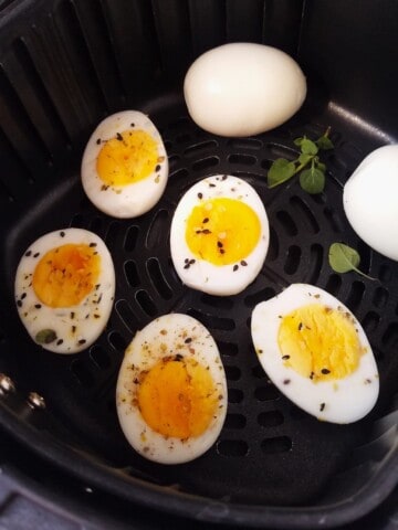 cooked eggs in an air fryer basket