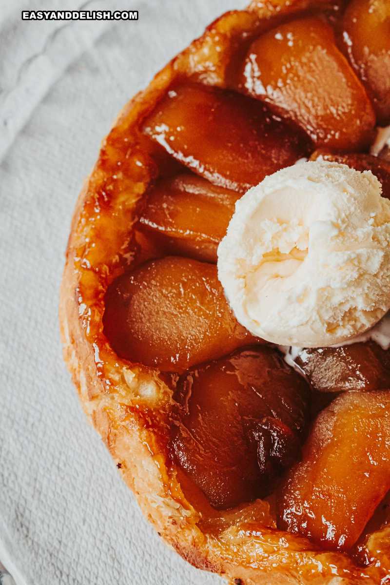 half of the French apple tart with an ice cream scoop on top