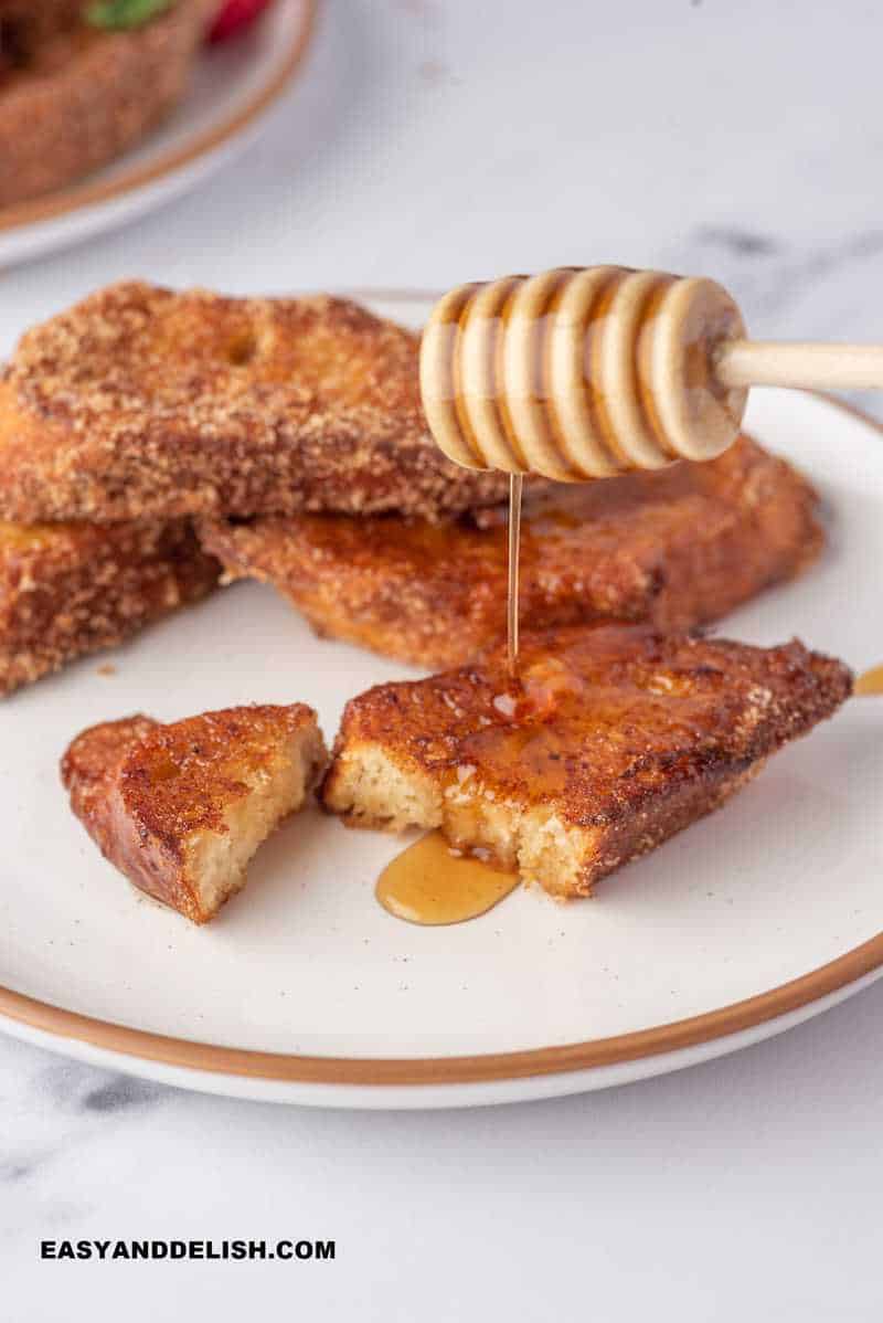 Brazilian french toast topped with honey 