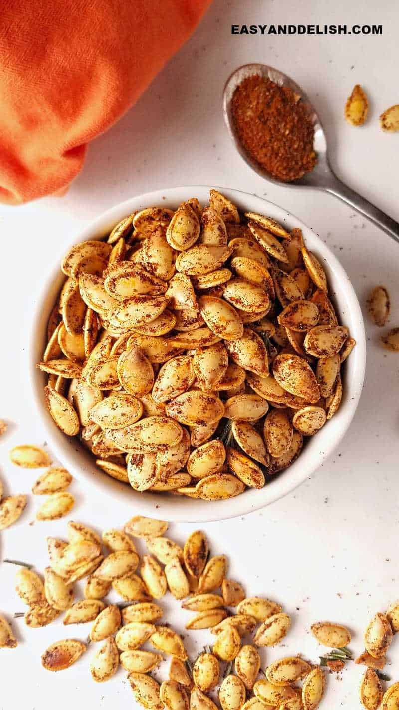 close up of clean, dry, and roasted pumpkin seeds in a bowl 