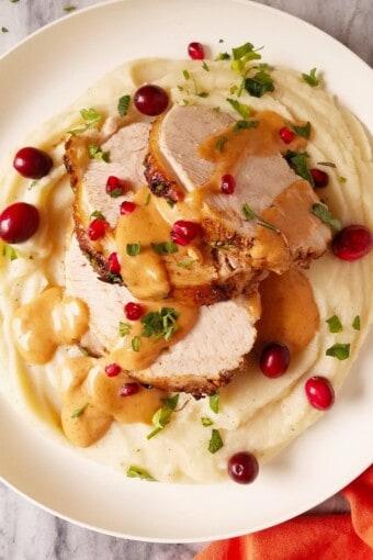 Instant Pot turkey breast sliced and served on top of mashed potatoes and drizzled with gravy