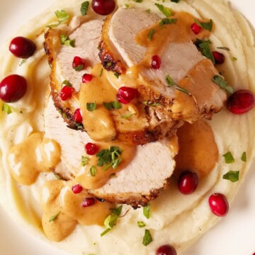 Instant Pot turkey breast sliced and served on top of mashed potatoes and drizzled with gravy