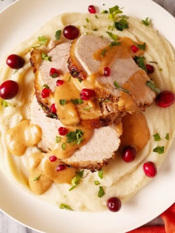 Instant Pot turkey breast sliced and served on top of mashed potatoes and drizzled with gravy