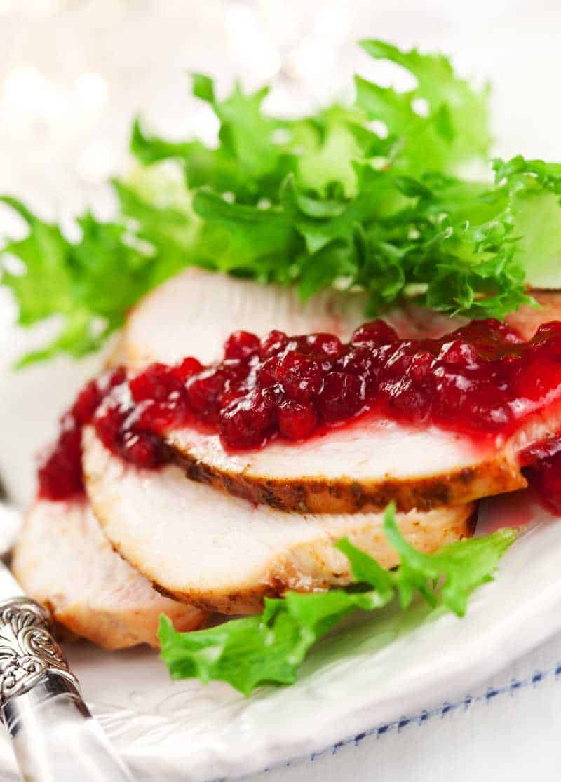 slices of turkey breast topped with cranberry sauce