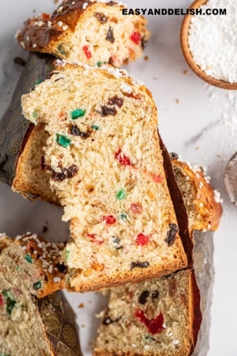 several slices of panettone with candied fruits over a table