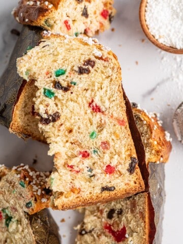several slices of panettone with candied fruits over a table