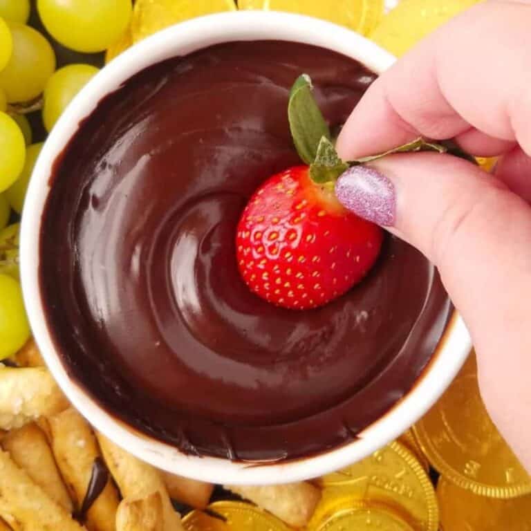 Strawberry dipped into a bowl of warm chocolate.