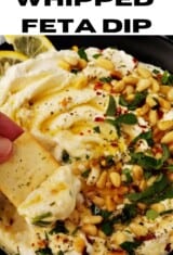 close up of whipped feta dip on a plate with a pita chip on the side