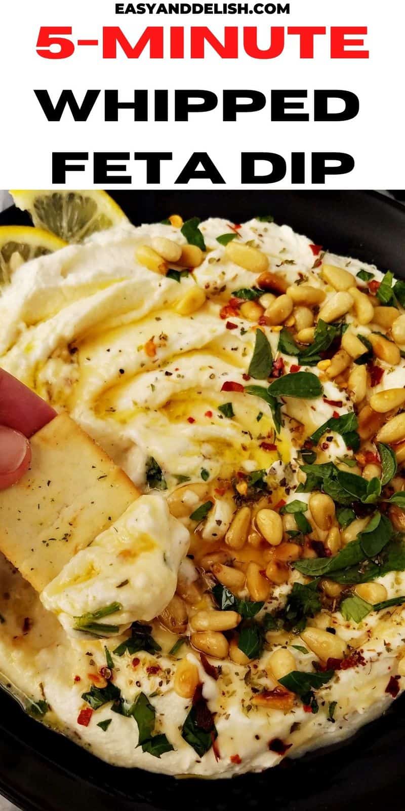close up of whipped feta dip on a plate with a pita chip on the side