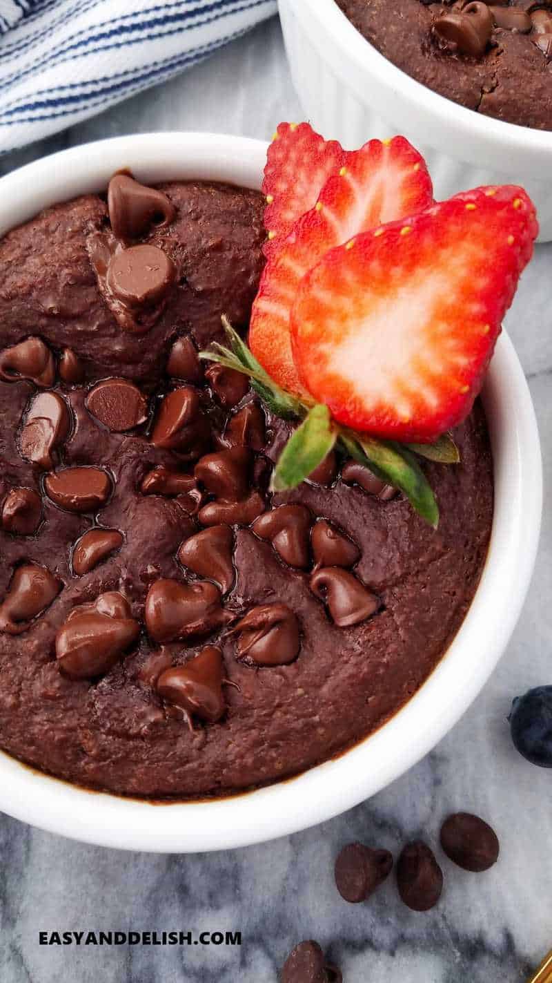 close up of half ramekin with healthy breakfast, chocolate chips and berries