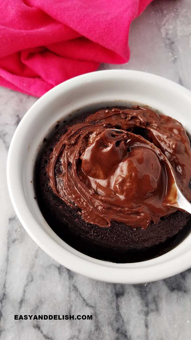 dessert with a soft center being spooned in a ramekin