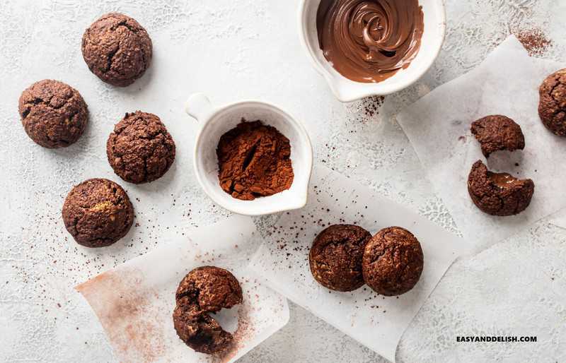 chocolate baked goodies on a table witha spread and cocoa powder on the sides