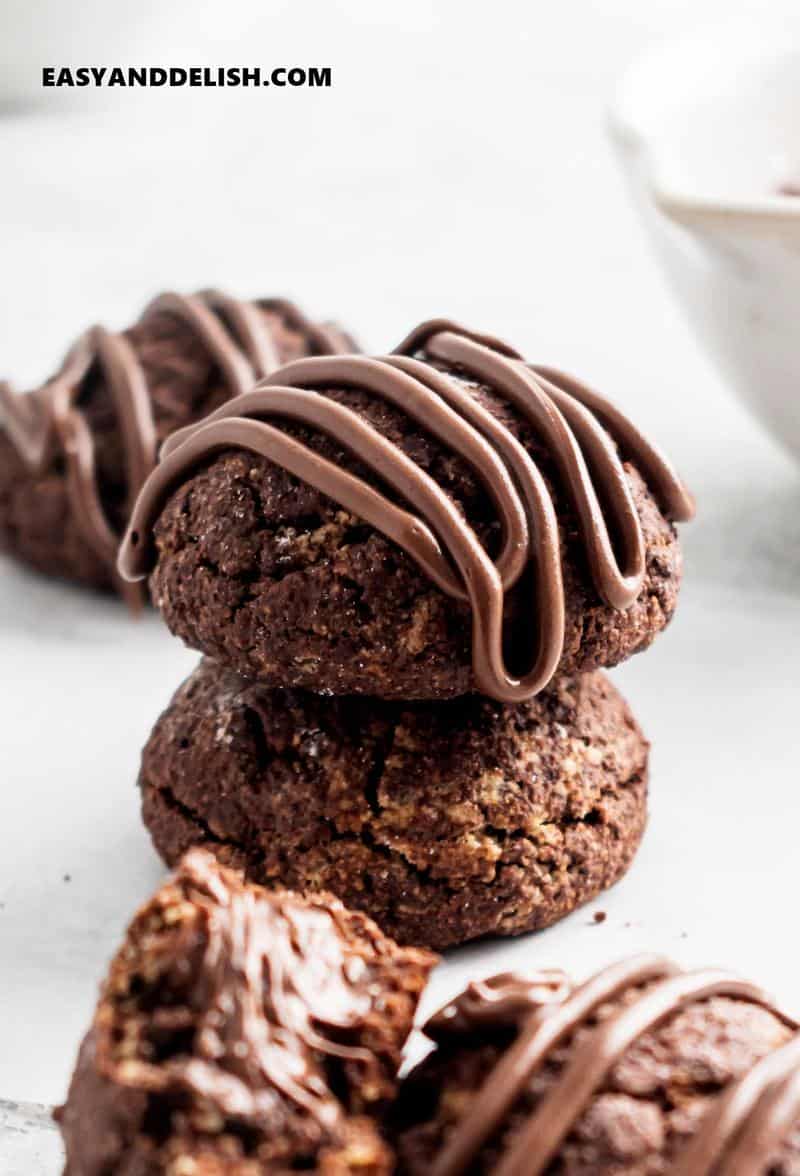 a pile of two nutella cookies drizzled with melted chocolate
