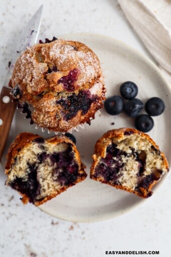 a plate with both whole and halved Jordan Marsh blueberry muffins