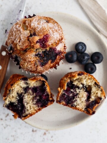 a plate with both whole and halved Jordan Marsh blueberry muffins