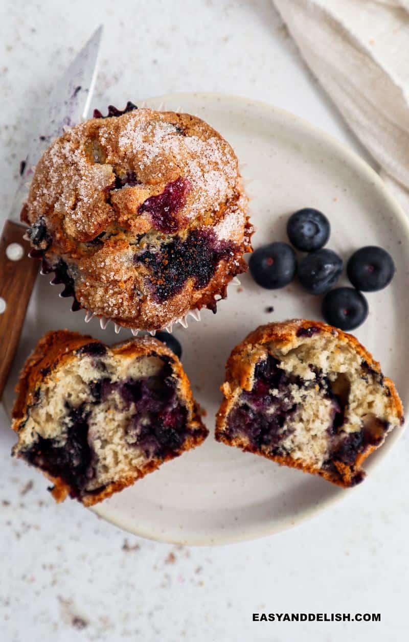 a plate with both whole and halved Jordan Marsh blueberry muffins