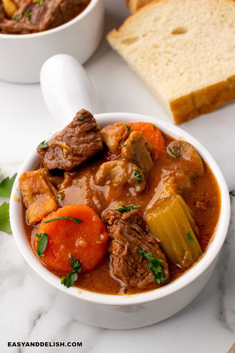 Irish beef and guinness stew in bowl with bread on the side