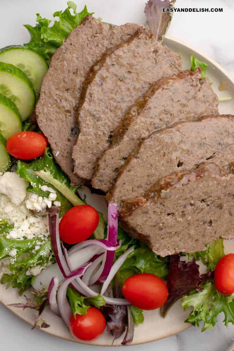 close up of thinly sliced gyro meat and Greek salad