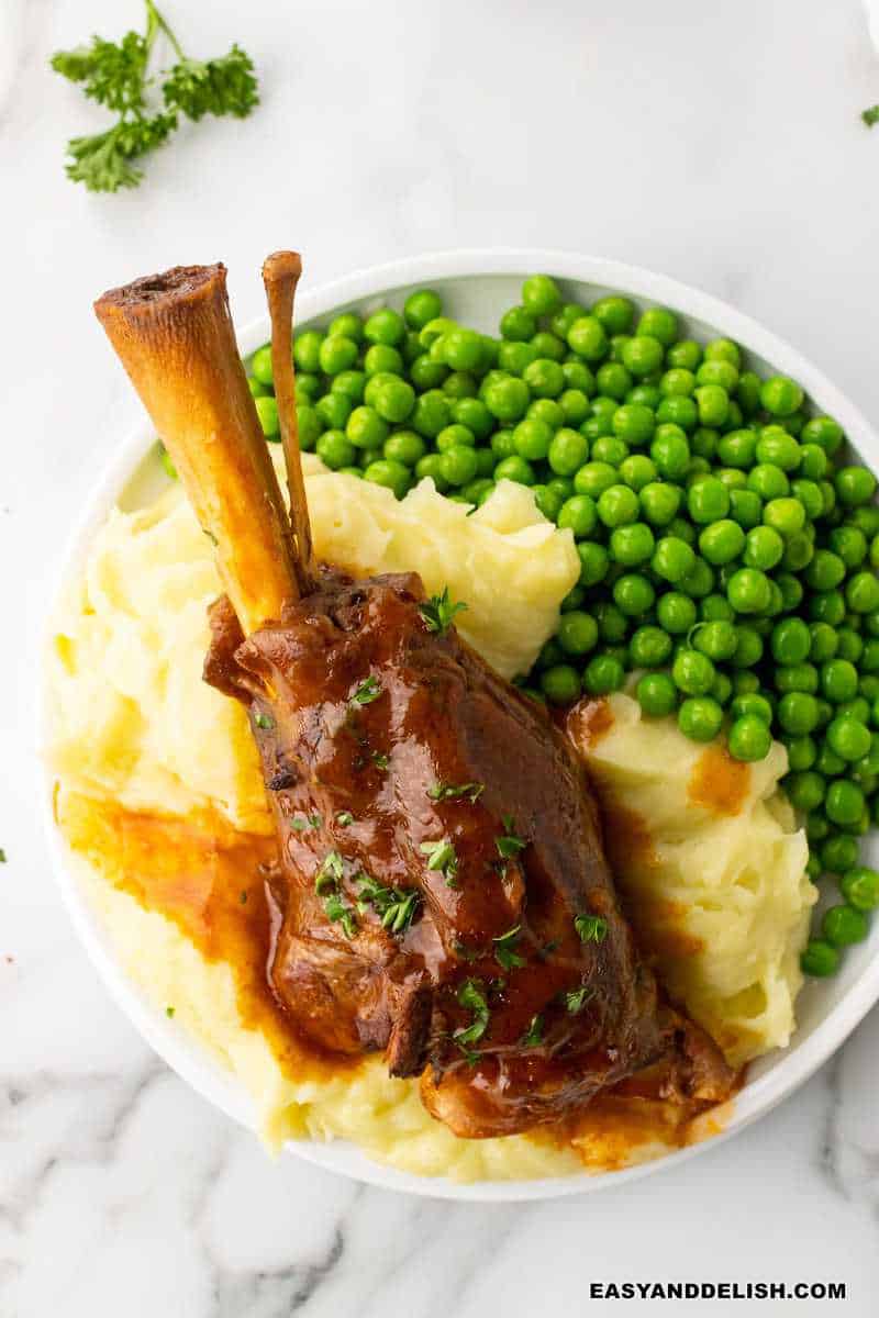 slow cooekr lamb shanks served over sides