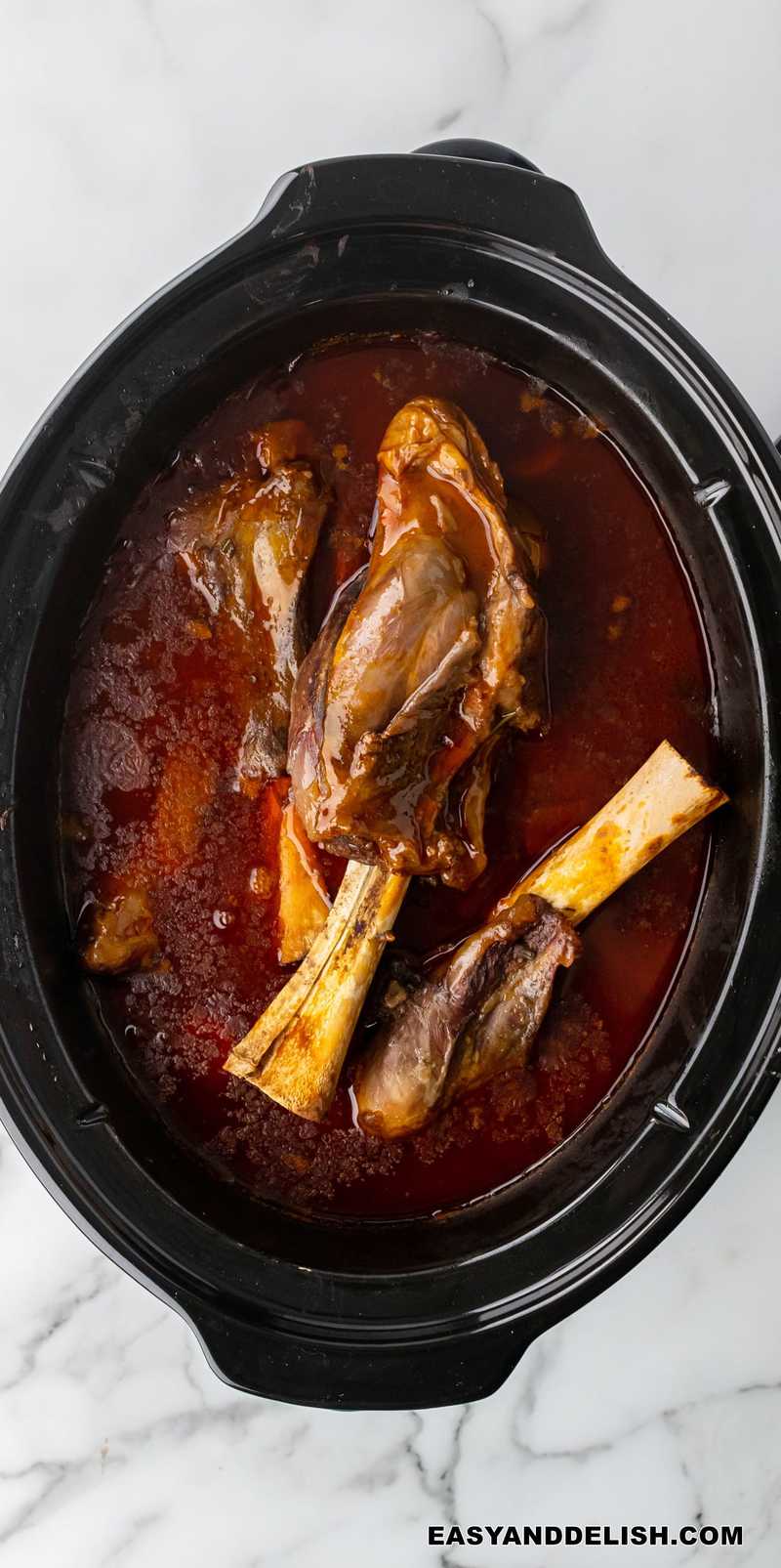 braised lamb shanks in a slow cooker with red wine sauce