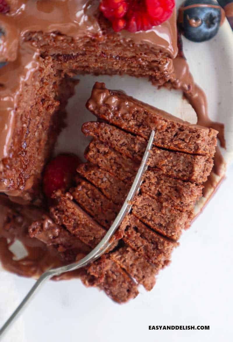 chocolate pancakes cut and held with a fork