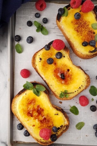 yogurt custard toasts garnished with berries and a napkin on the side