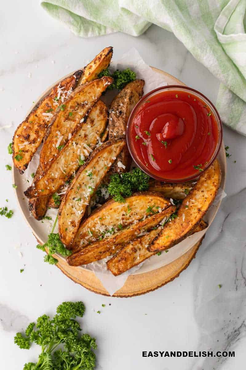 air fried potato wedges served on a plate with ketchup on the side