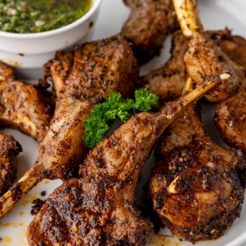 A plate of food with meat and herbs