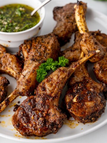 A plate of food with meat and herbs