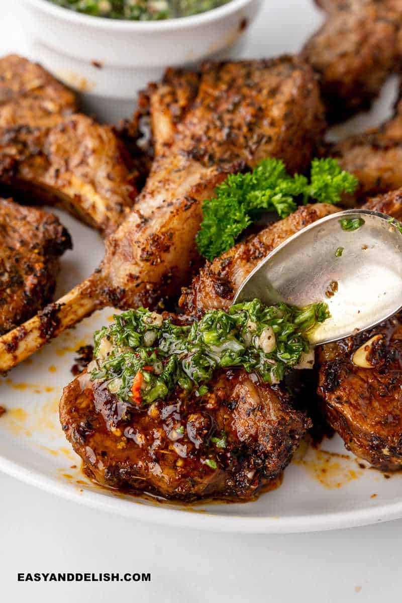 chimichurri sauce spooned over air fryer lamb chops