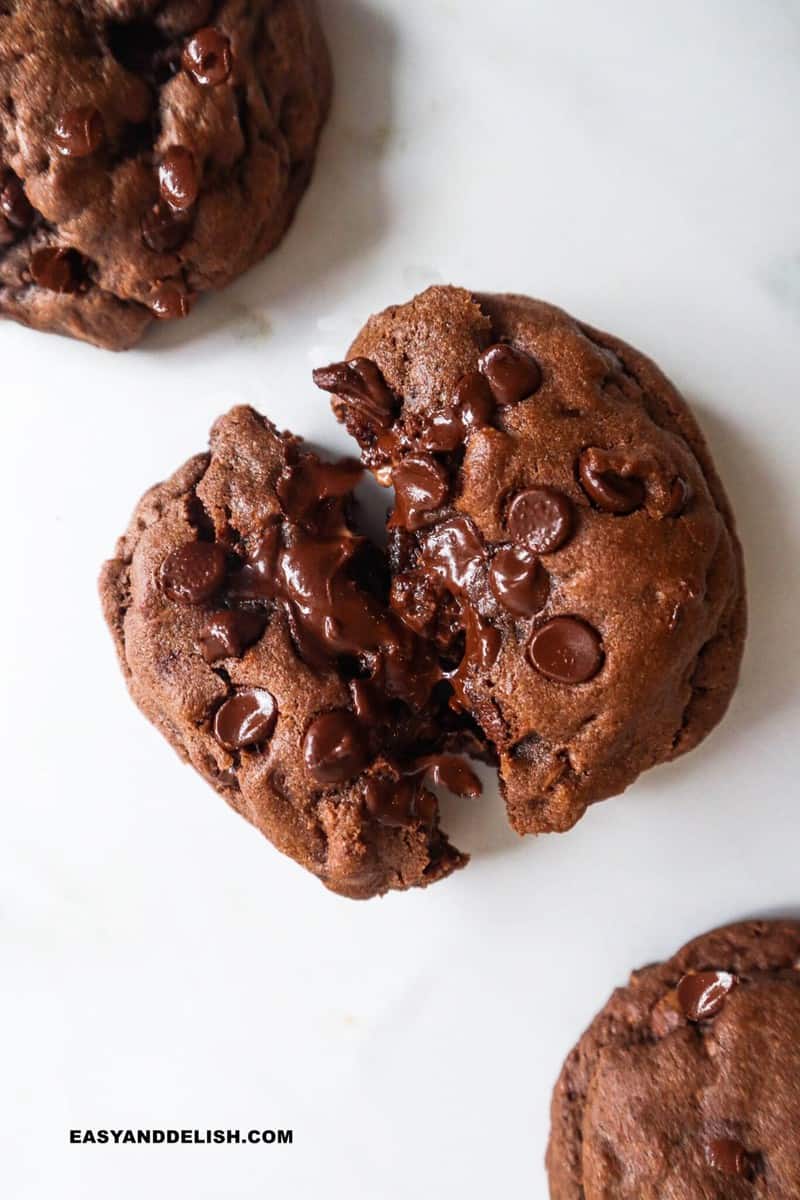 a close up of a double chocolate cookie cut in half 