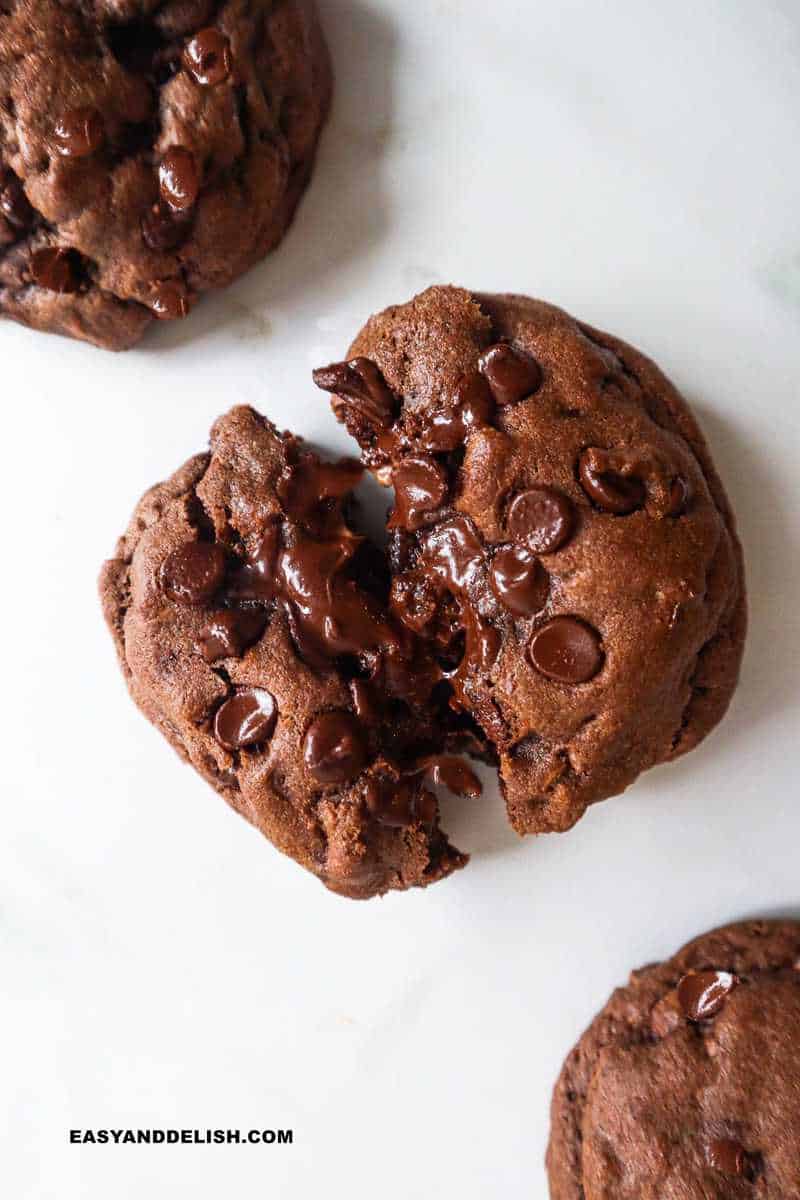 a close up of a double chocolate cookie cut in half 