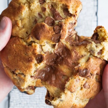 levain bakery chocolate chip cookie split in half showing goeey center