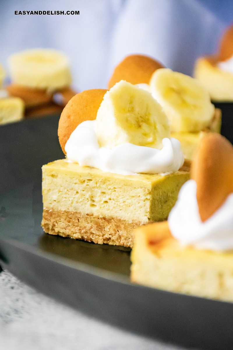 close up of banana pudding cheesecake squares in a tray