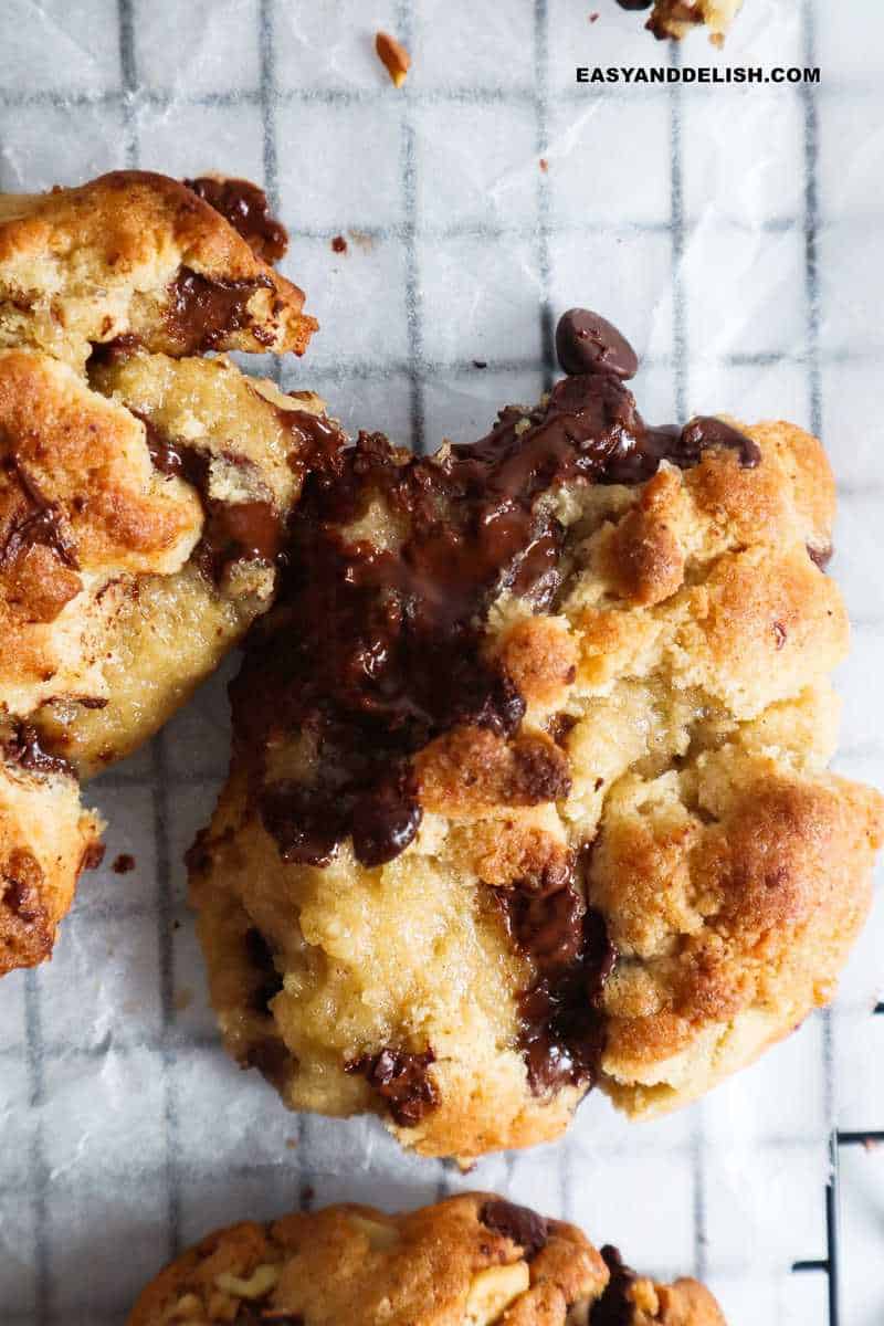 close up of a chocolate chip walnut cookie with melty chocolate center