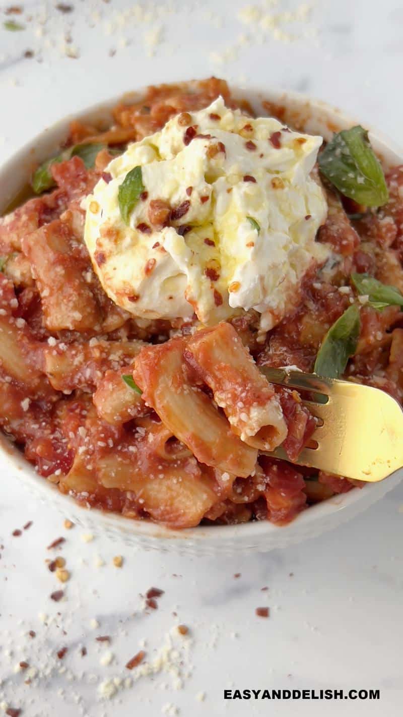 a forkful of keto penne pomodoro removed from a bowl