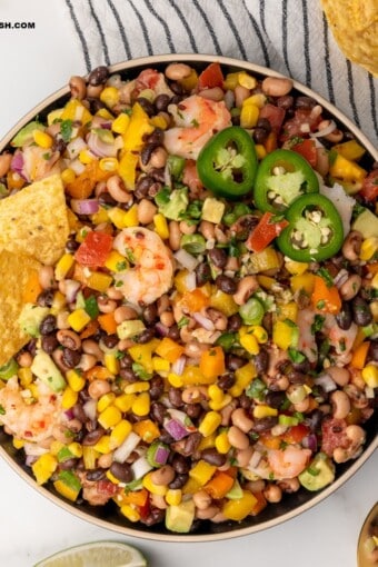 A bowl of Texas caviar with tortilla chips on top served as a dip