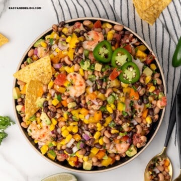 A bowl of Texas caviar with tortilla chips on top served as a dip