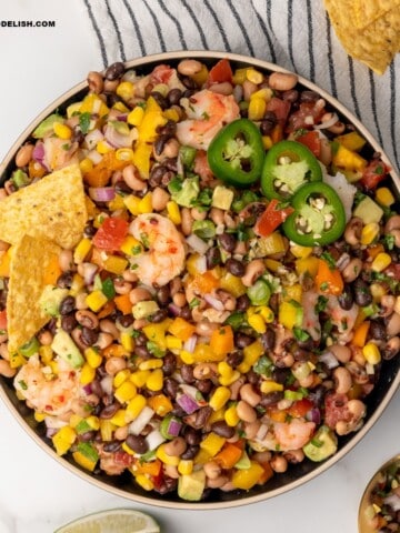 A bowl of Texas caviar with tortilla chips on top served as a dip