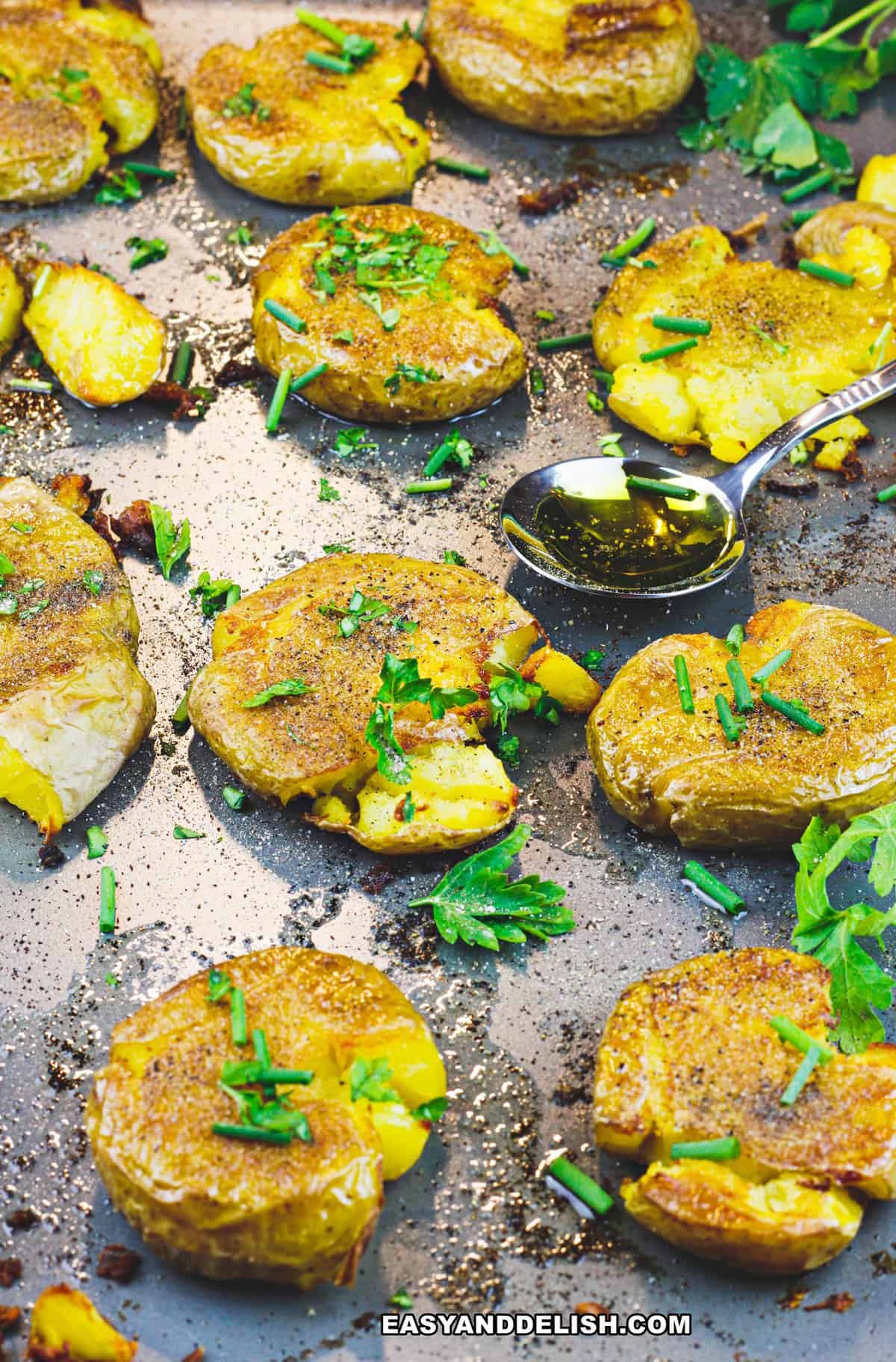 roast starchy vegetables in oven baking sheet with a spoon of olive oil on the side