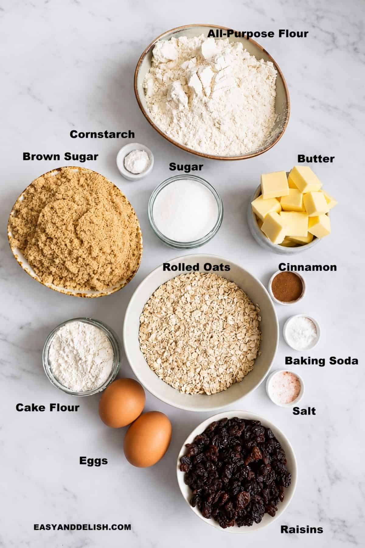 Oatmeal raisin cookie ingredients arranged on a white countertop.