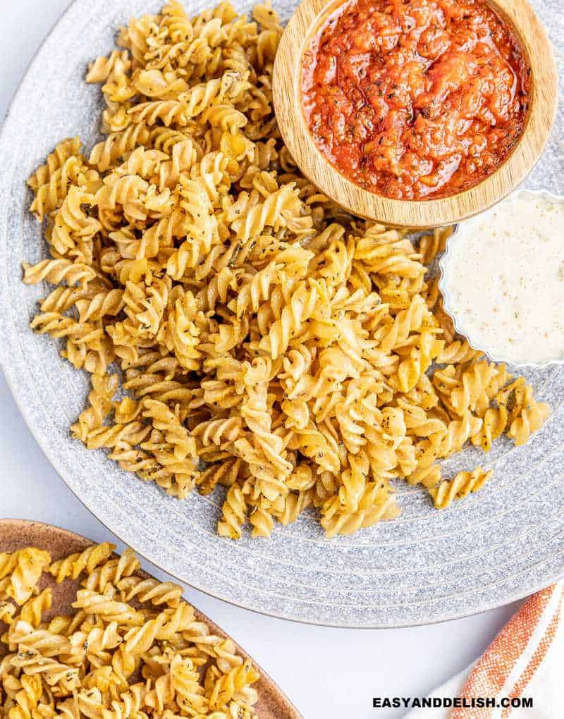 air fryer pasta chips in aplate with dipping sauces on the side