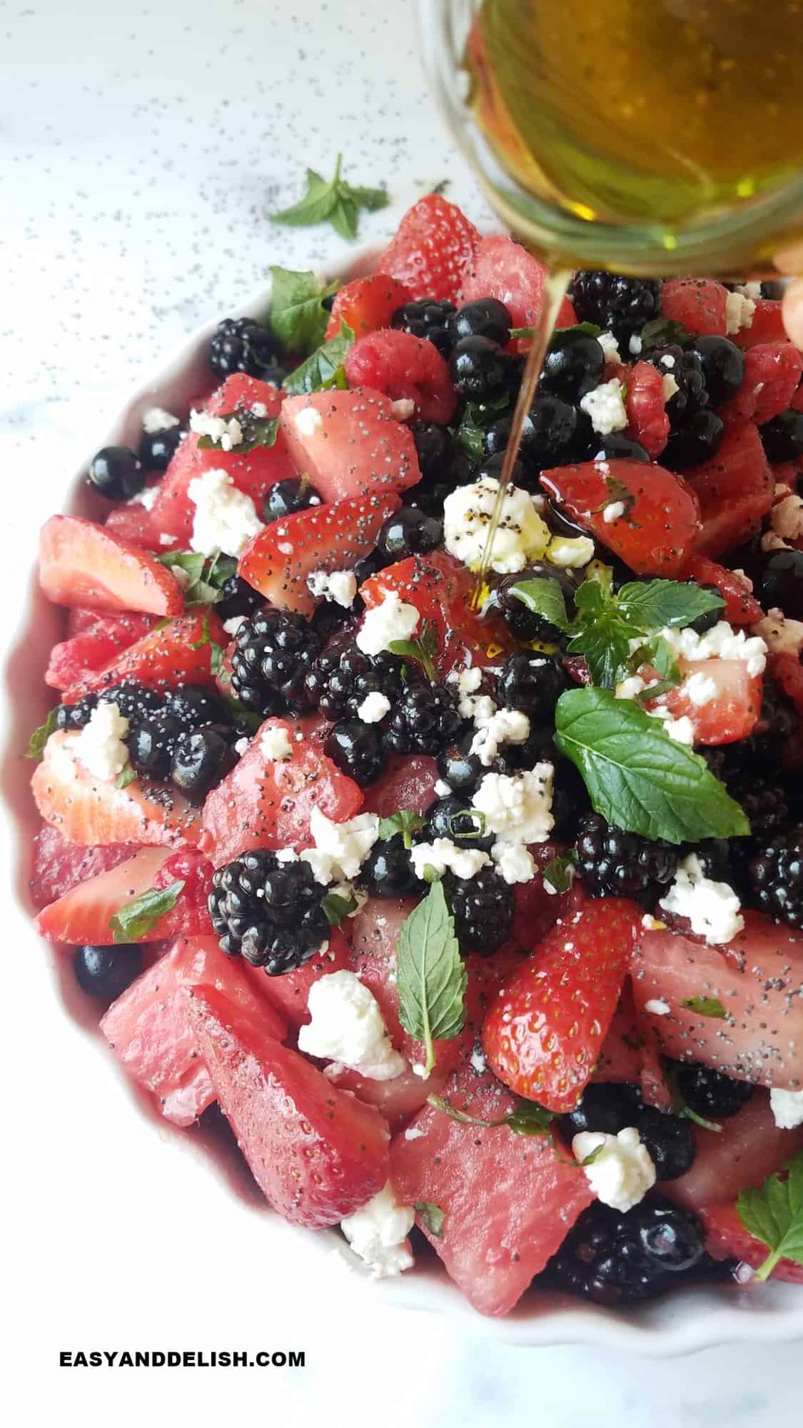 berry salad drizzled over with the dressing