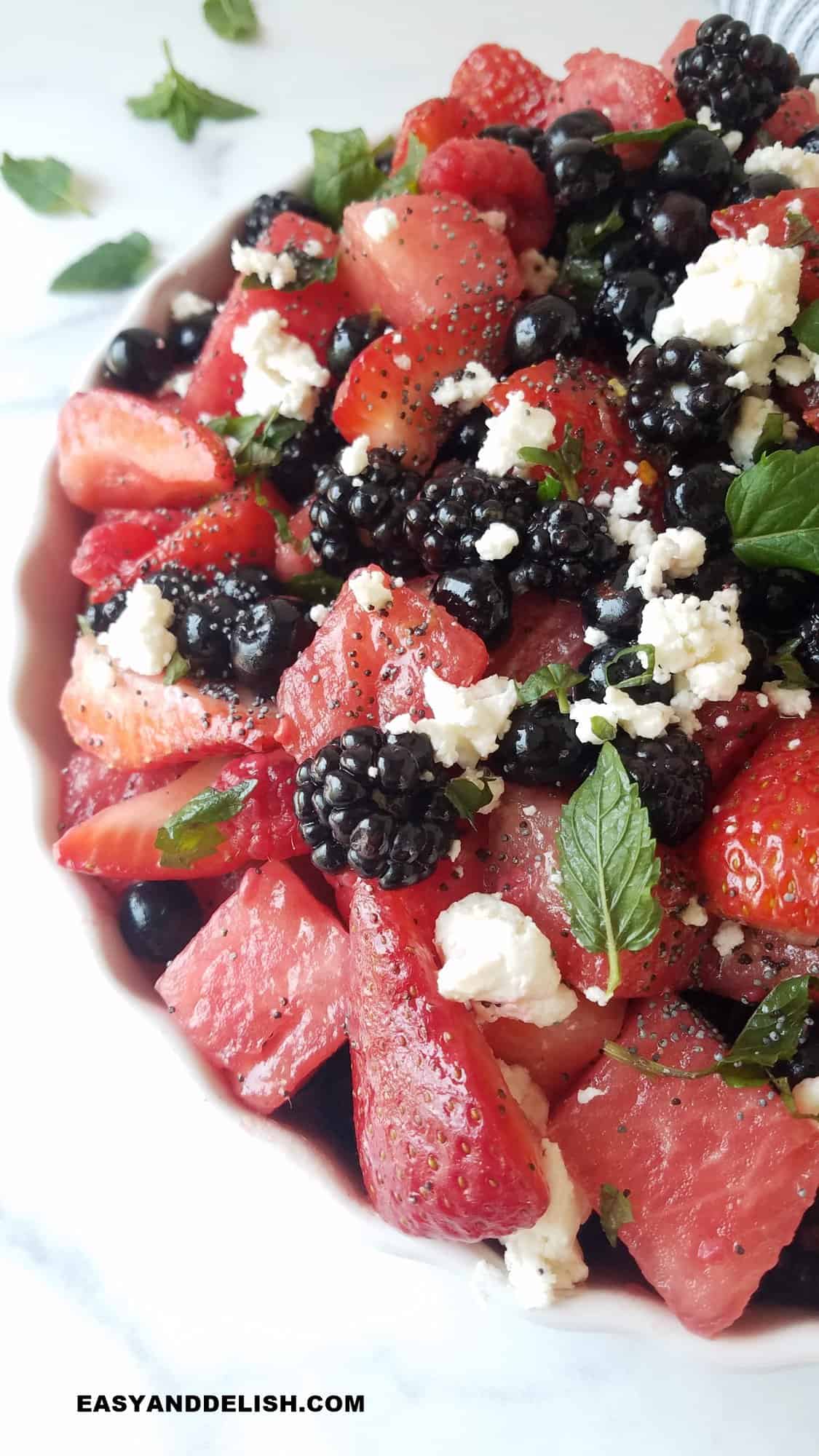 close up of half bowl of fresh fruits tossed with dressing