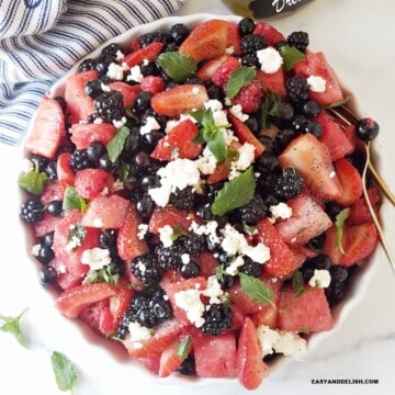close up of a bowl of berry salad tossed with lemon poppy seed dressing