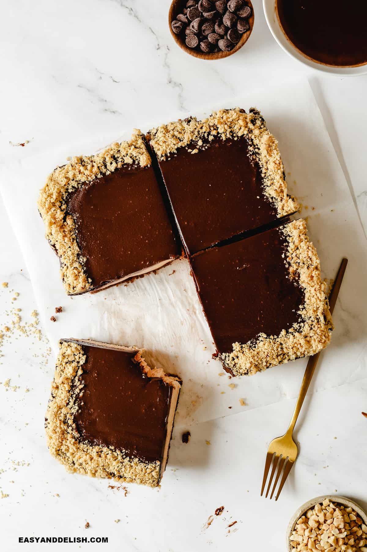 A piece of chocolate cake on a plate with a fork and knife