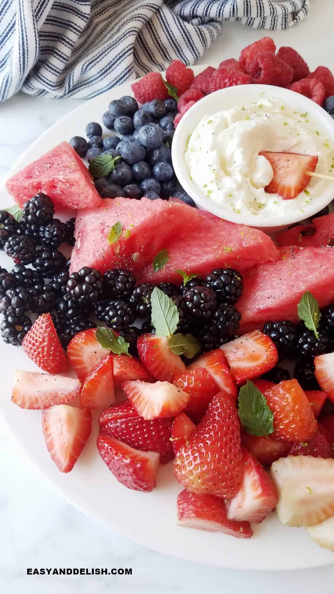 close up of a platter with fresh fruits and a fluffy spread